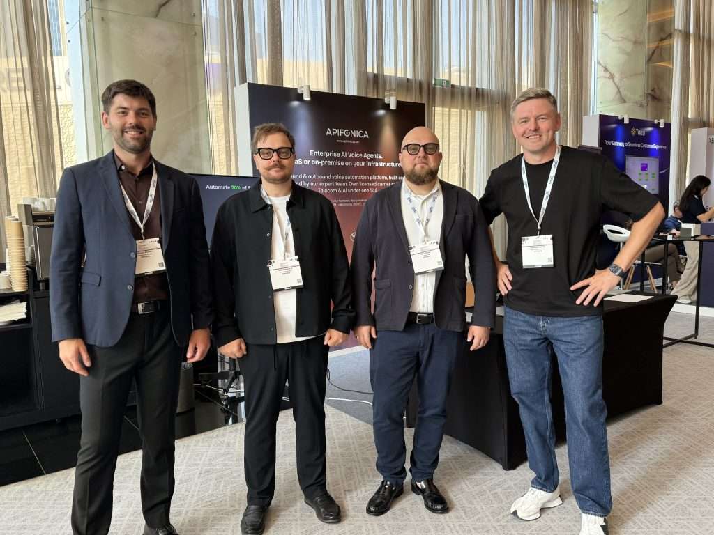 Four Apifonica team members pose for a group photo at their exhibition stand during Customer Experience Live Show Middle East 2026 in Dubai.